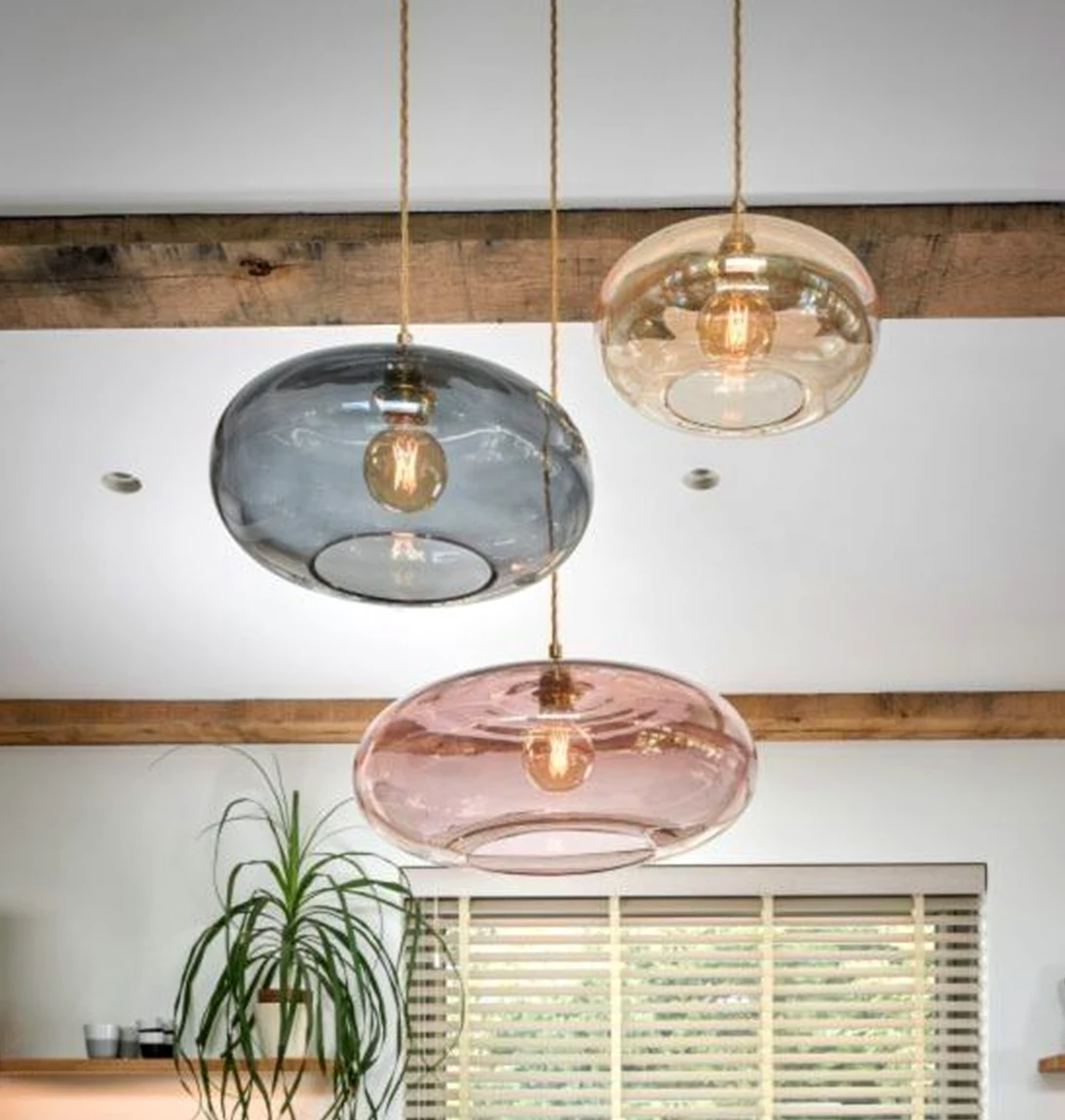 Simple wood shelving brings a useful note of contrast, making the view feel open and lived-in.